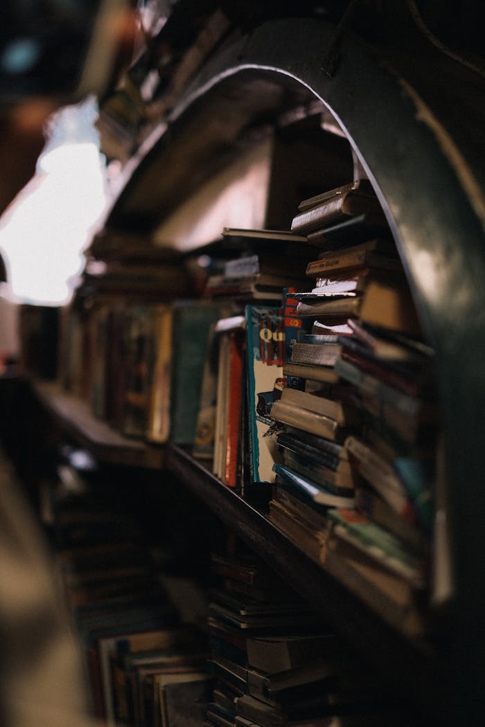 A warm-toned image of a crowded vintage bookshelf filled with books, creating a nostalgic atmosphere.