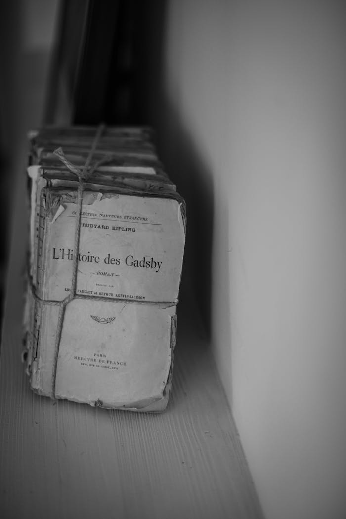 A stack of vintage books tied together, captured in monochrome for a classic look.